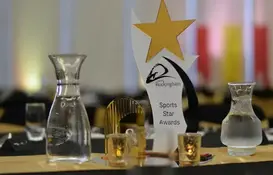a table with a trophy and glass