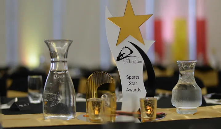a table with a trophy and glass