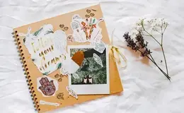 a notebook with stickers and flowers