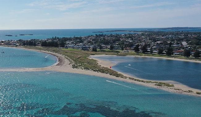 a beach with water and land