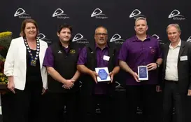 a group of people holding awards