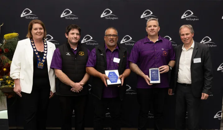 a group of people holding awards