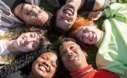 a group of people lying in a circle