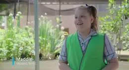 a girl in a green vest