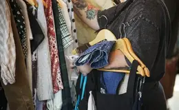 a person holding clothes on swingers