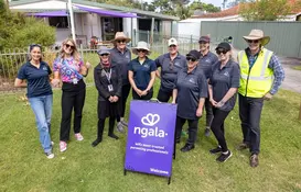 a group of people standing in a yard