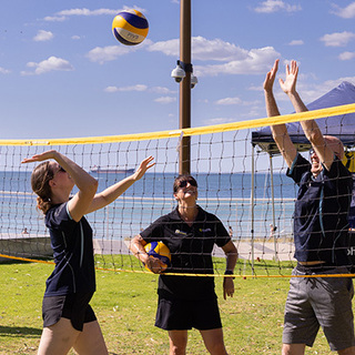 a group of people playing volleyball