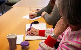 a person writing on a notebook