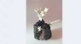a black object with white flowers