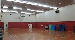 a gym with a basketball court and a net