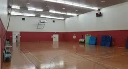 a gym with a basketball court and a net