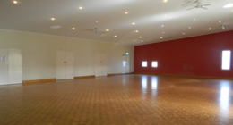 a room with a red wall and a wood floor