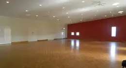 a room with a red wall and a wood floor