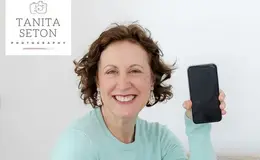 a woman holding a cell phone