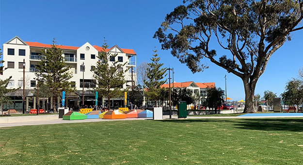 a park with colorful benches and trees
