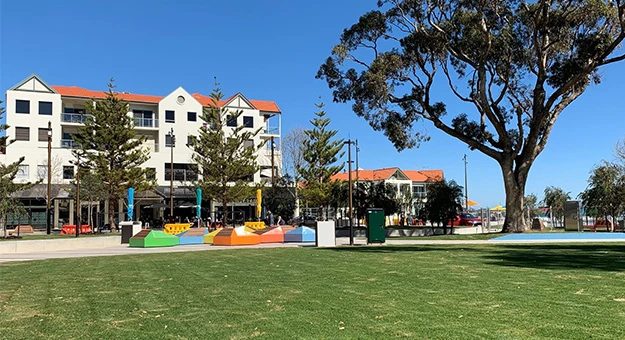 a park with colorful benches and trees