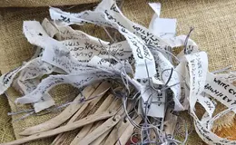 a group of wooden sticks with tags on a cloth