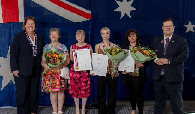 a group of people holding certificates