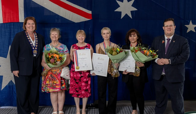 a group of people holding certificates