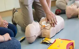 a group of people sitting on the floor with cpr training