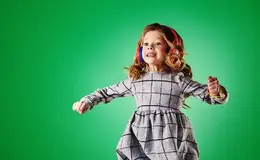 a girl wearing headphones and dancing