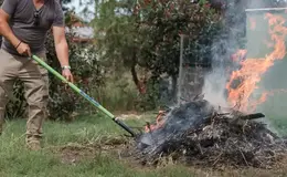 a person using a shovel to clean a fire
