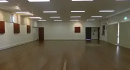 a room with a wood floor and a door