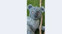a stuffed koala bear on a branch