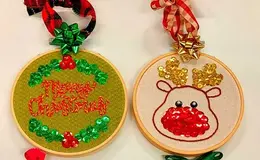 a pair of embroidered ornaments