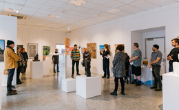 a group of people in a room with art