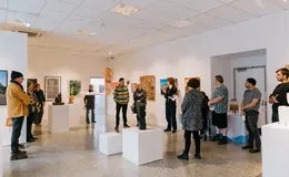 a group of people in a room with art