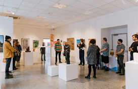 a group of people in a room with art
