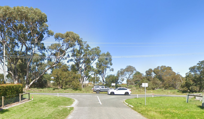 a road with cars parked in the middle of the road