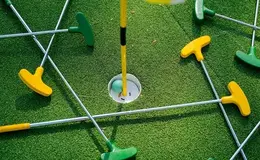 a golf balls and tees in a hole
