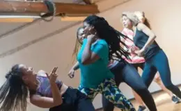 a group of women dancing in a room