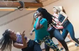 a group of women dancing in a room