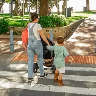 A family crossing a zebra crossing toward Churchill Park, Rockingham Foreshore.