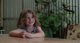 a girl sitting at a table