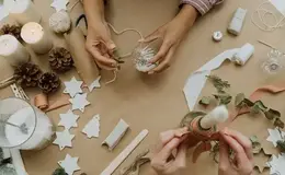 hands holding a glass and a candle