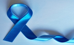 a blue ribbon on a white surface