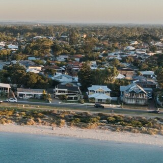 a beach with buildings and a body of water