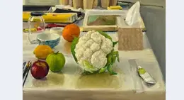 a cauliflower and fruit on a table