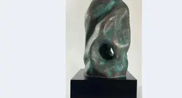 a sculpture on a black stand