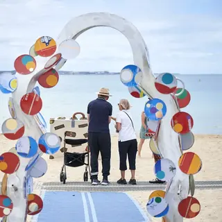 a group of people standing on a beach