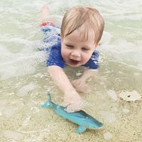 Toddler playing in shallow water.