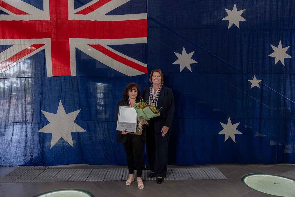 Stephenie with mayor Deb Hamblina against an Australian flag backdrop.