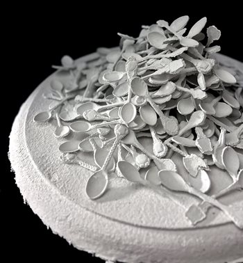 A pile of paper cast souvenir spoons