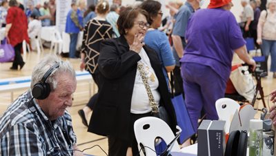 Attendees speaking with stallholders at the Seniors and Carers Expo