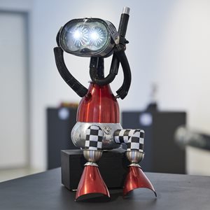 A metal sculpture of a robot made from upcycled aluminium, stainless-steel, cookware, electrics.