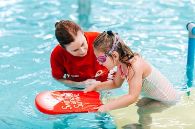 Swim school teacher with student Swim school teacher with student